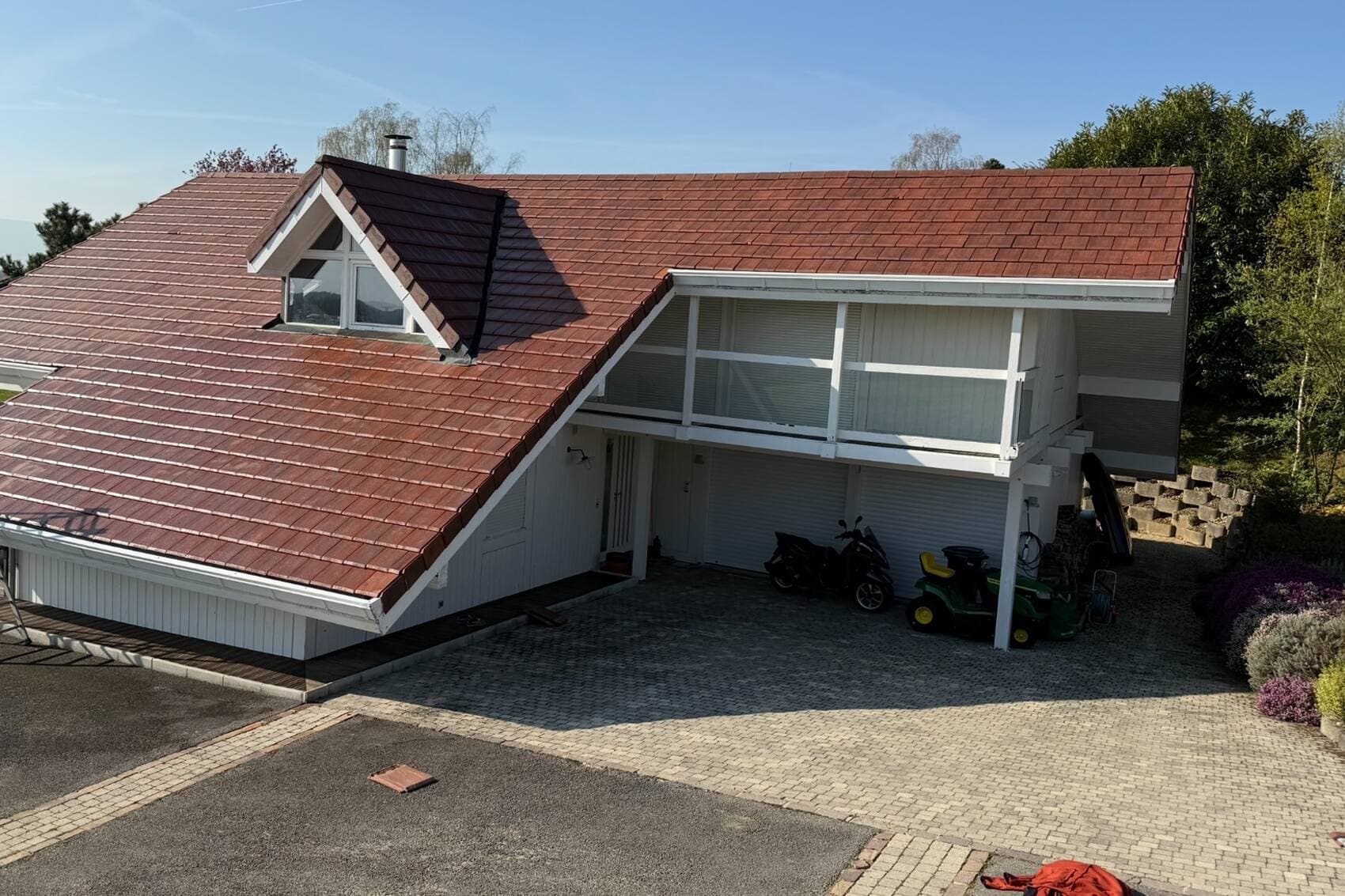 Toiture en tuile terre cuite d'une maison du Pays de Gex démoussée par PROUX — après
